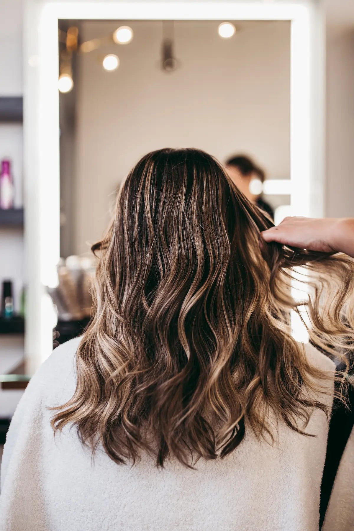 Hair stylist styling clean, healthy hair after removing product buildup