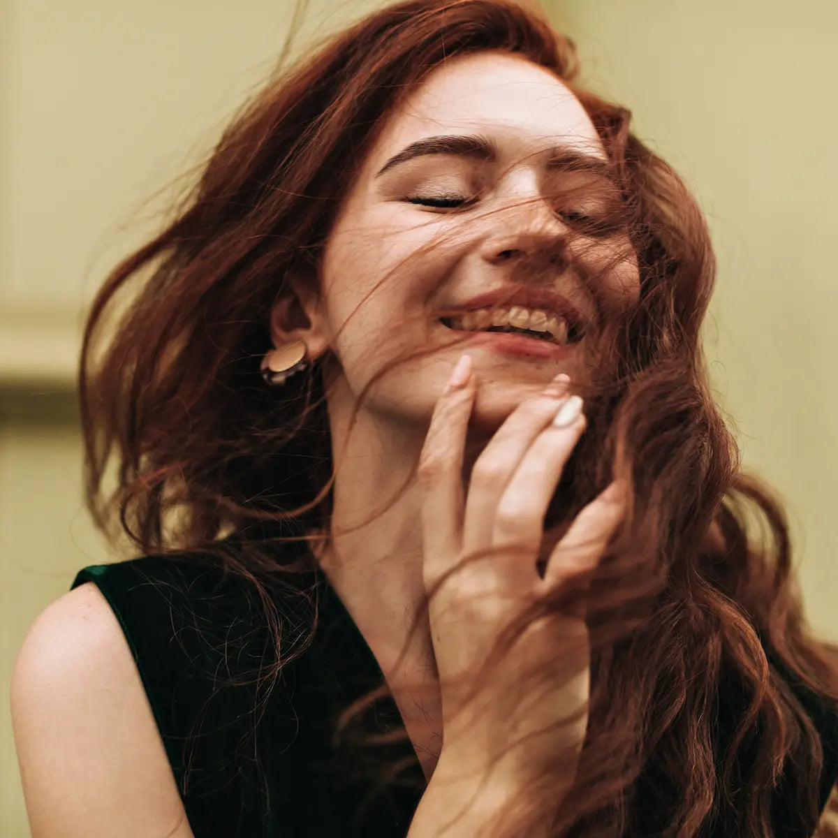 Happy woman with fresh, fragrant red-brown hair smiling