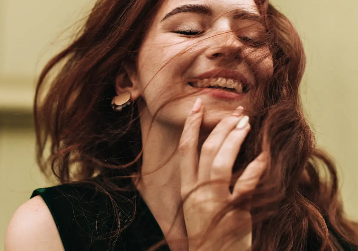 Happy woman with fresh, fragrant red-brown hair smiling