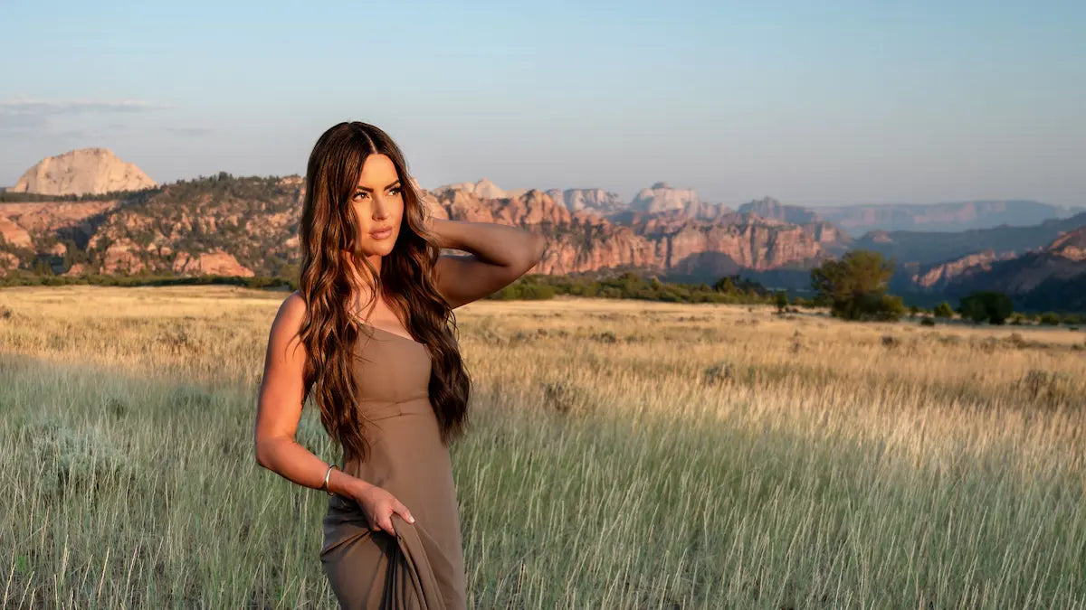 Long wavy brown hair styled with a crisp middle part
