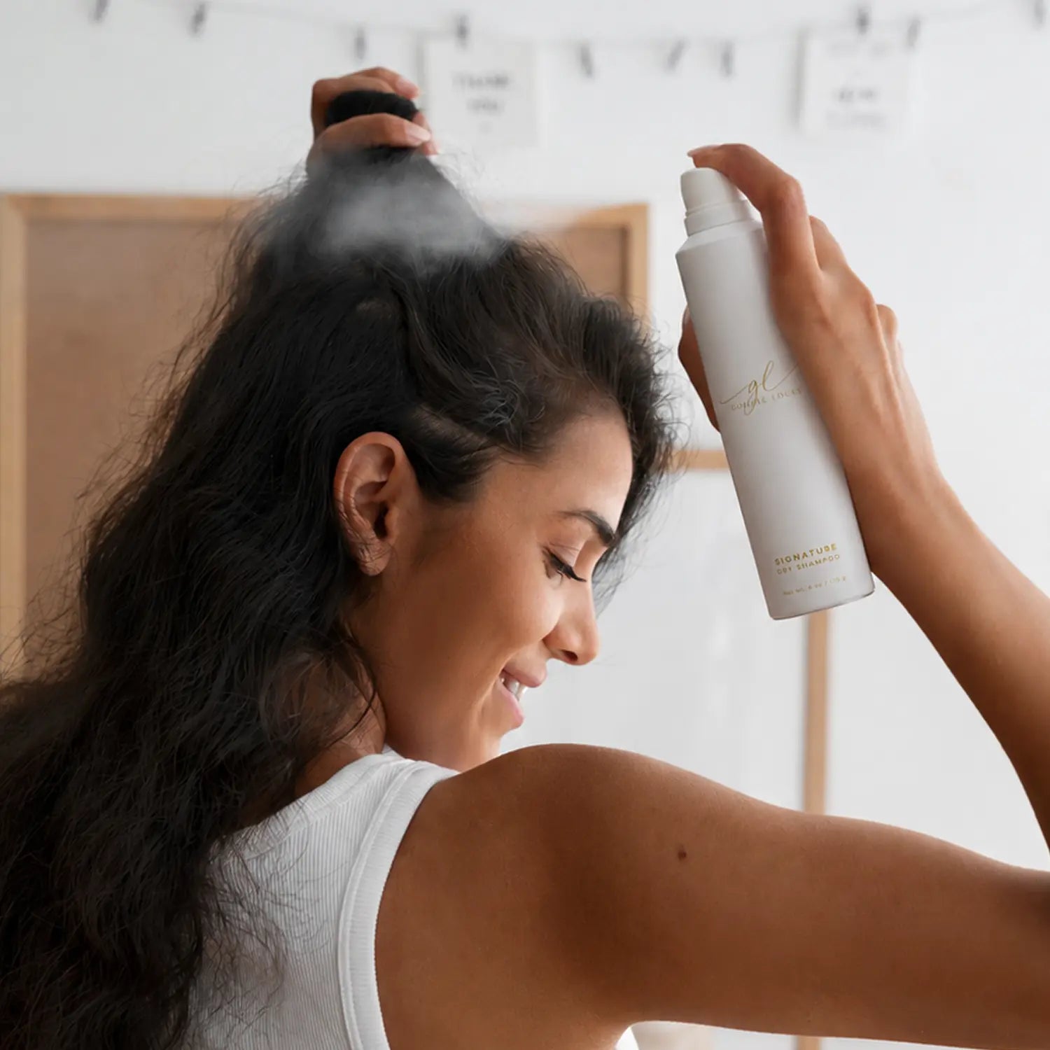 woman applying herself goldie locks signature dry shampoo spray