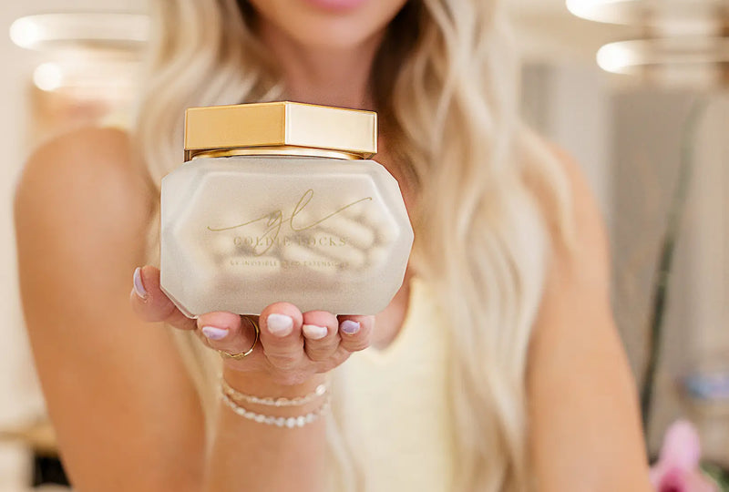 Woman holding hair supplements jar