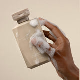 Clarifying Shampoo Bottle in Hand