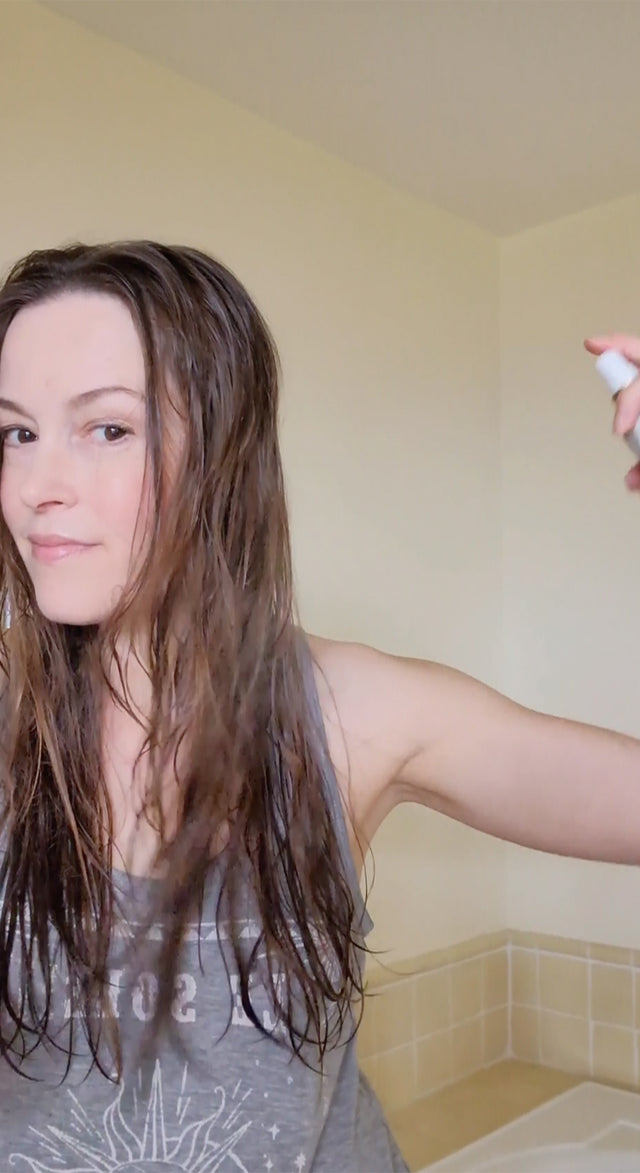 girl using blow dry spray before styling hair